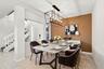 The open-concept floor plan seamlessly connects the living room and elegant formal dining area, creating an inviting setting for memorable dinners and