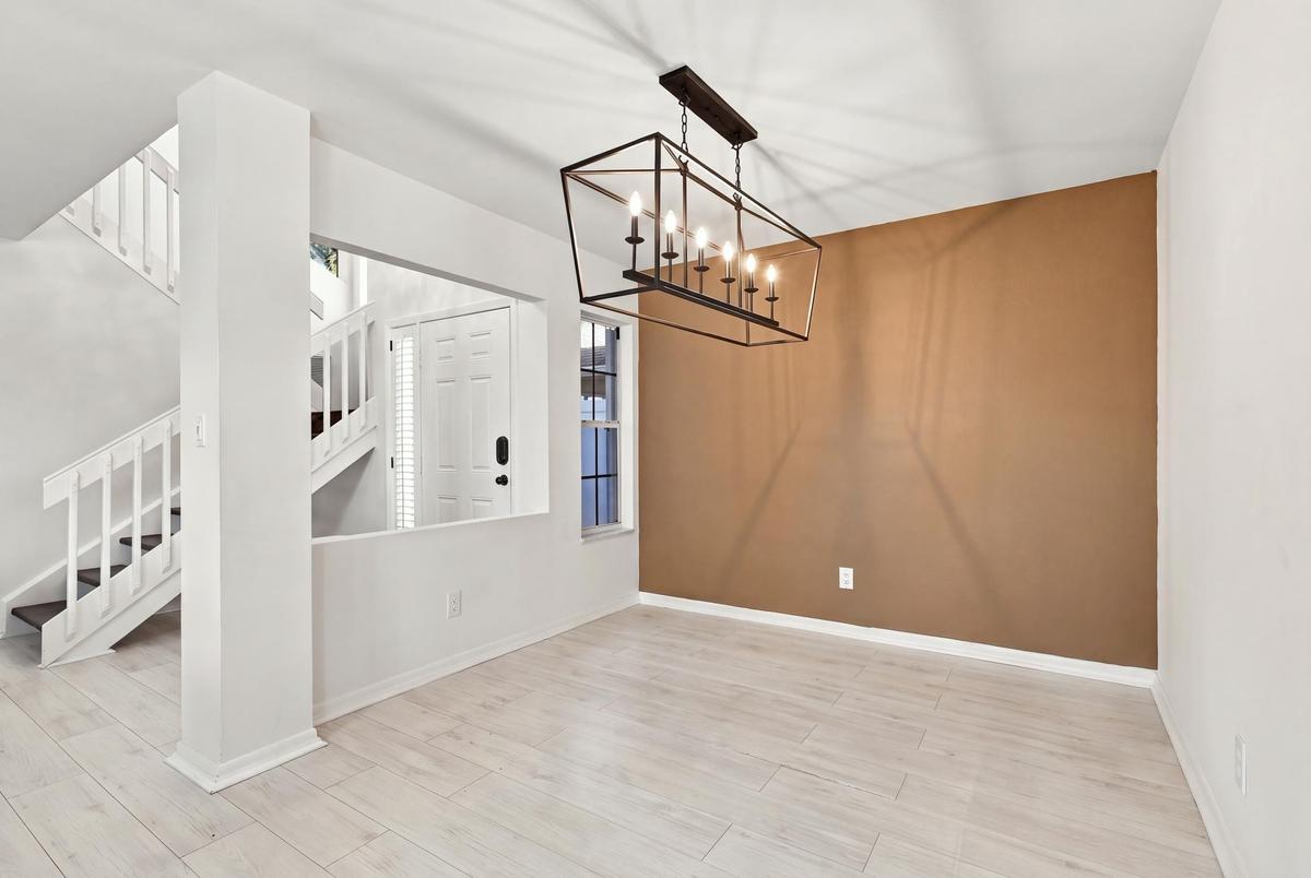 The open-concept floor plan seamlessly connects the living room and elegant formal dining area, creating an inviting setting for memorable dinners and