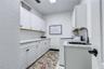 Cabinets galore in laundry room and utility sink!