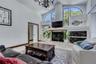 Large family room with oval windows and gas fireplace!