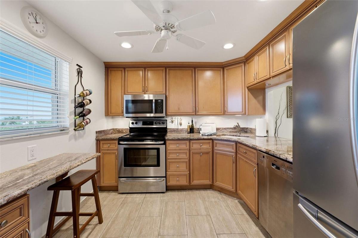 Well-appointed kitchen with solid-wood cabinetry and granite countertops.