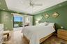 Tranquil primary bedroom with soothing green tones.