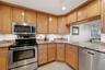 Bright kitchen featuring stainless-steel appliances and abundant cabinetry.