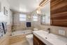 Contemporary bath with floor-to-ceiling tile and refined finishes.