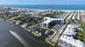Aerial of back of building showing marina and waterway as well as Gulf