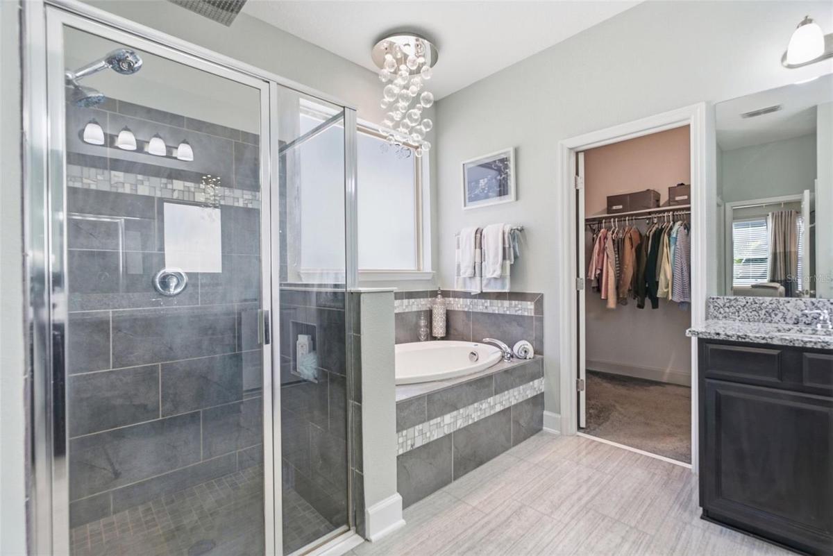 En-suite bathroom boasting a garden tub and frosted glass window.