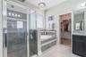 En-suite bathroom boasting a garden tub and frosted glass window.