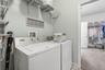 Indoor laundry room with access to the primary walk-in closet