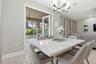 Dining area with chandelier and views of the trees out back