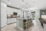 Living room and kitchen connected by large-format wood-look tile