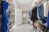Primary walk-in closet with built-in shelving