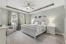 Primary bedroom retreat featuring a tray ceiling and ample natural light.