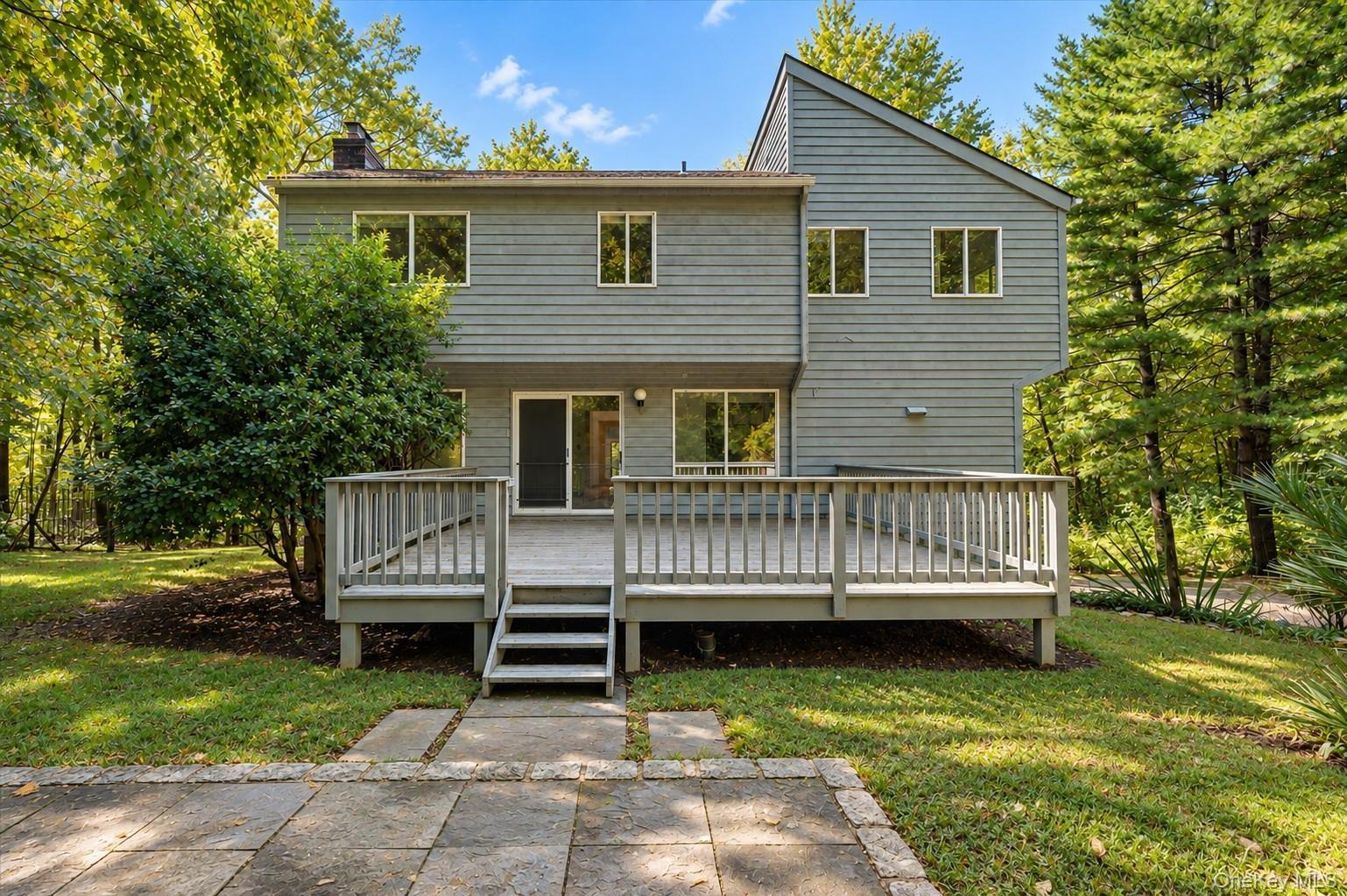 Back of the home showing deck and patio