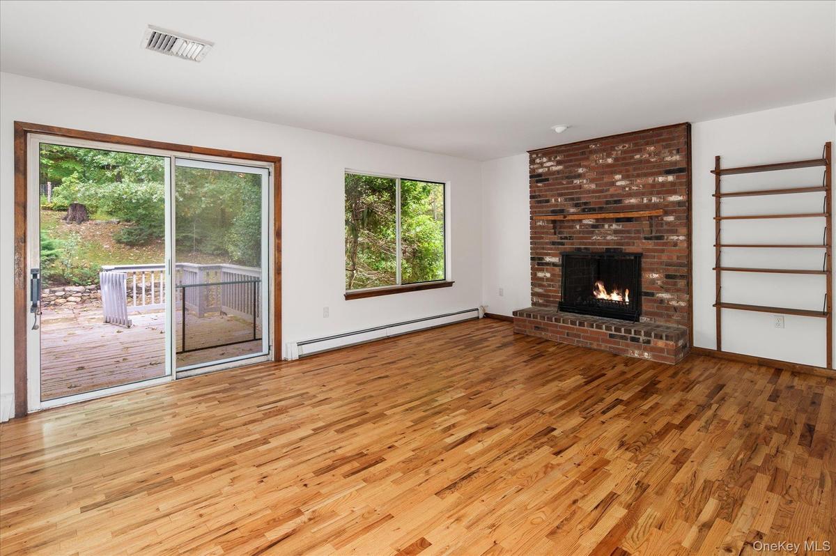 Family room adjacent to the kitchen with sliders to the deck