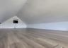 Wood-finish flooring, recessed ceiling lighting, and a built-in wall-mounted air conditioning unit