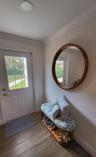 Recessed ceiling lighting, crown molding, paneled door with glass inserts, wood-finish flooring, and a round wall mirror