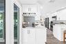 Custom built-in bar area with herringbone tile backsplash.
