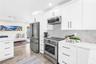 Stainless appliances, range with convection and air fryer functions, deep storage drawers and a herringbone shell tile backsplash.