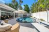Heated AND Chilled six feet deep saltwater pool with sun shelf and umbrella option.