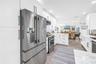 Stainless steel French style three drawer refrigerator and lots of panty space.