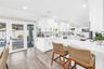 Casual seating to "help" the cook in this Showstopper Kitchen! Quartz countertops have a very light blue hue!