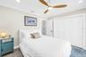 Second bedroom with custom closet built-ins.