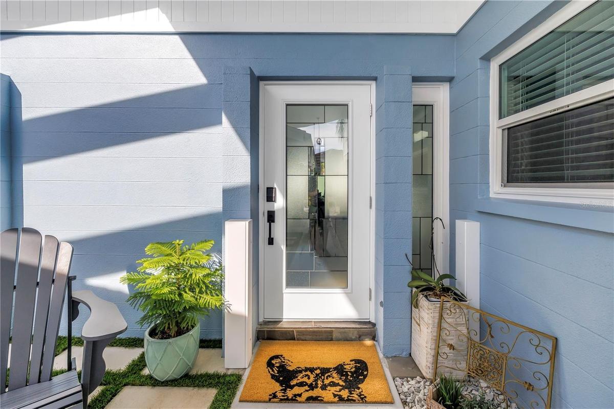 Fido says welcome home! Custom front door with inlaid glass and glass side panel.