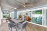 impact-rated pocket sliders disappear completely into the wall, dramatically opening the living room to the lanai and pool