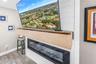 Custom mantel is an A/V storage drawer over the electric fireplace.