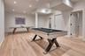 Recessed lighting, light wood-finish flooring, white walls, and multiple panel doors