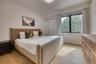 Hardwood flooring, recessed lighting, and a large window with black framing