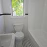 Bathroom featuring tile patterned flooring, a bathing tub, and tile walls
