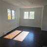 Empty room featuring a baseboard heating unit