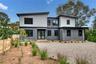 Contemporary two-story residence with a gray and white paneled exterior