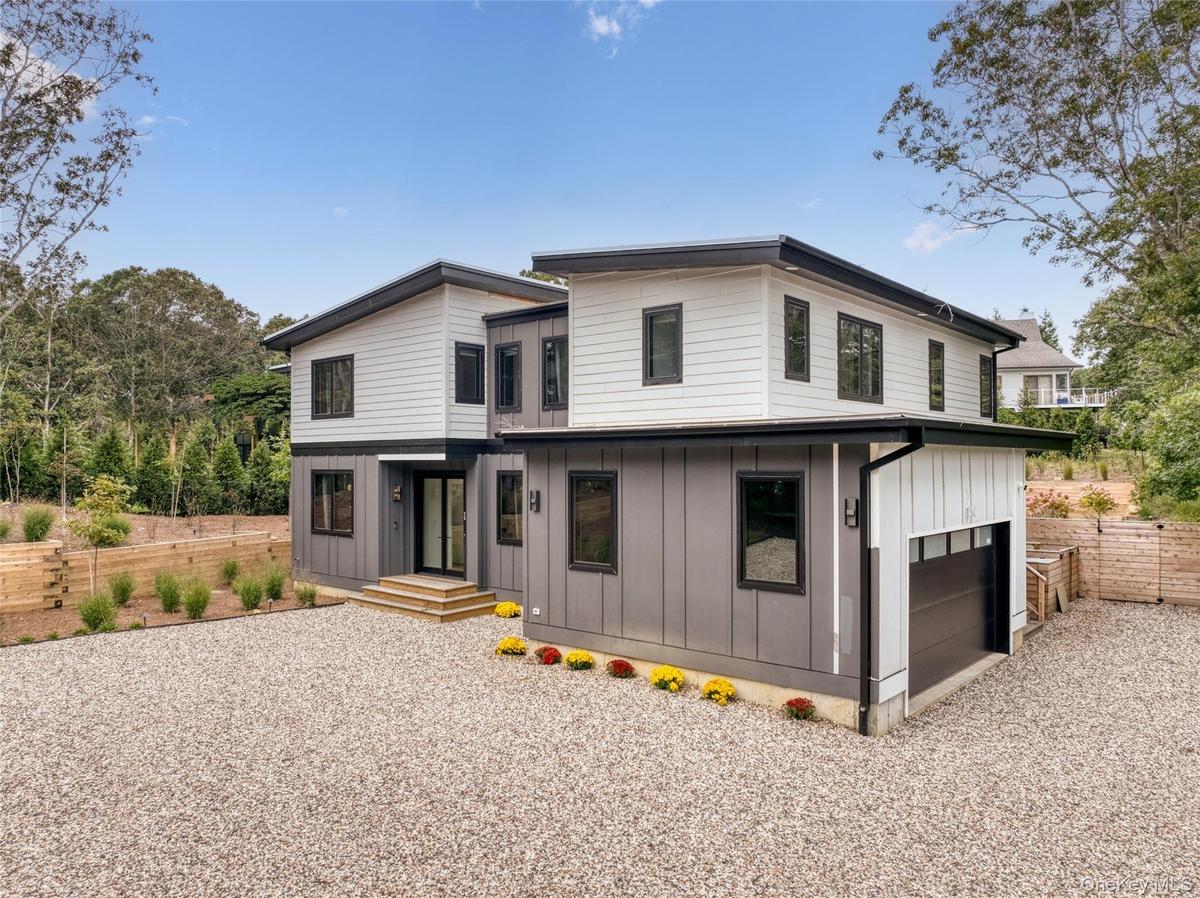 Contemporary exterior with white horizontal siding and grey vertical paneling