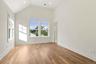 primary bedroom with cathedral ceilings