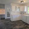 Kitchen with dishwasher, dark hardwood / wood-style flooring, and white cabinetry