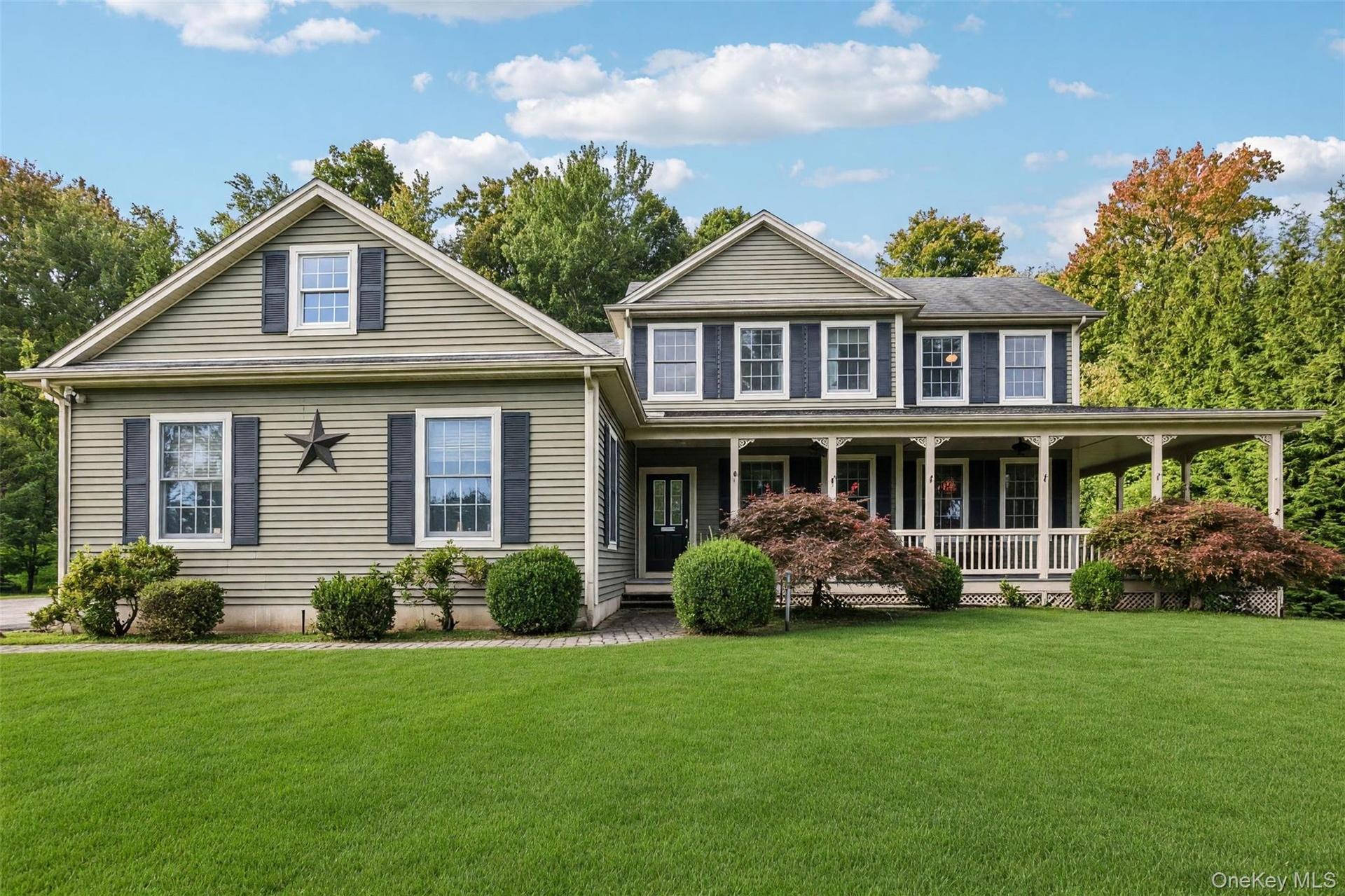 Gable rooflines and green siding with black louvered shutters