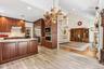 Hardwood flooring and light wood-finish flooring complement the extensive wood cabinetry
