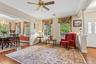Wood-finish flooring, crown molding, and a ceiling fan with integrated lighting