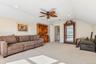 Recessed lighting, sloped ceiling, ceiling fan, neutral wall paint, and carpeted flooring