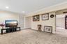 Recessed lighting, crown molding, light-colored wall paint, and neutral carpeting