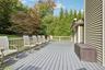 Expansive gray composite deck featuring a light-toned railing and exterior siding