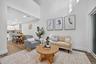 Living room with light wood finished floors and recessed lighting