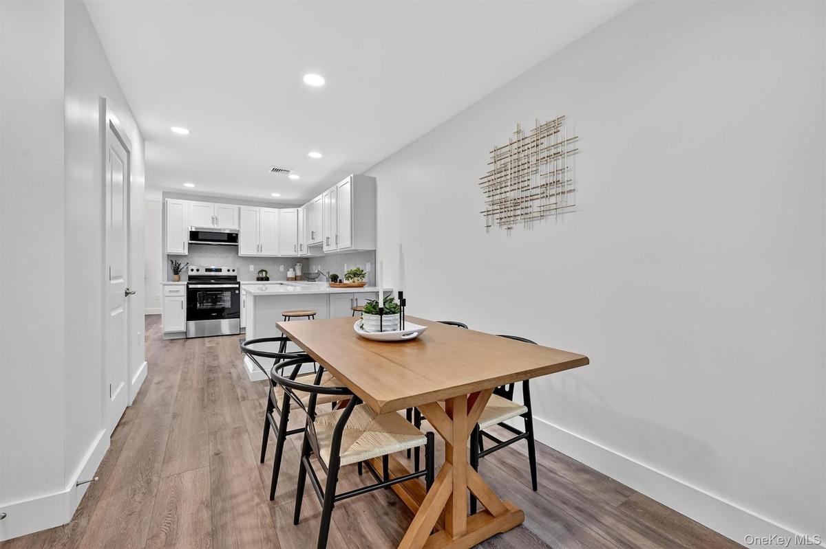 Dining area featuring light wood finished floors and recessed lighting