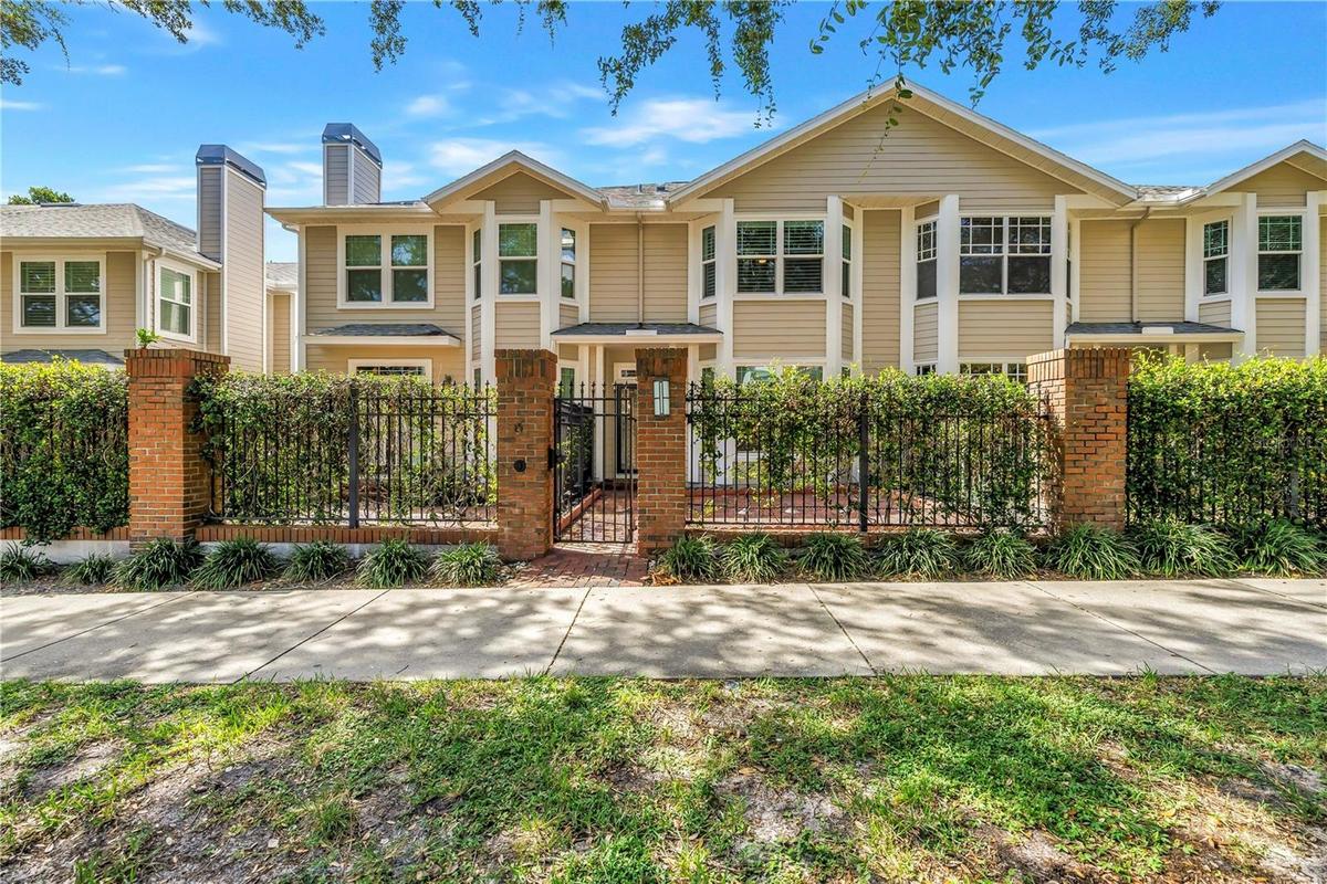 Front exterior of this beautifully updated residence with a private gated brick courtyard and 2-car garage.