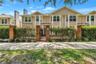 Front exterior of this beautifully updated residence with a private gated brick courtyard and 2-car garage.