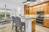 Another view of the renovated kitchen shows its generous cabinetry and easy connection to the front entry and main living areas.