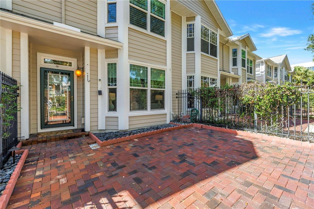 Private brick courtyard creates a welcoming outdoor entry and an added sense of privacy in the heart of downtown.