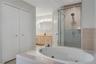 Tub and shower in the primary bathroom